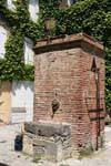 Grimaud, fontaine en briques rouges, France.