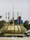 Travailleur nettoyant les cuivres sur l'esplanade, Mausolée Mohamed V Rabat, Maroc.